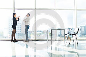 Couple of business man, woman talk about document Object tool in office room against blue sky window with houses