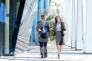 A couple of business persons in formal clothes photo