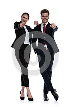 Couple in business suits pointing photo