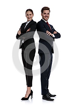 Couple in business suits standing back to back