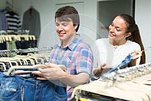 Couple buying blue jeans at store