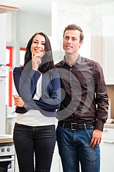 Couple buying domestic kitchen furniture store