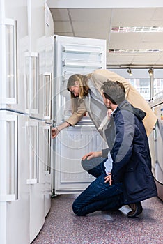 Couple Buying Domestic Refrigerator In Hypermarket