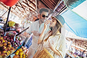 Couple buying fruits and vegetables in a market