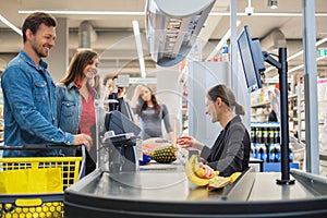 Couple buying goods in a grocery store