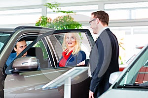 Couple buying new car at dealership