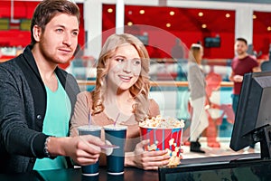 Couple buying popcorn and coke