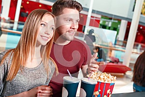 Couple buying popcorn and coke
