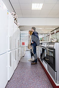 Couple Buying Refrigerator In Hypermarket photo