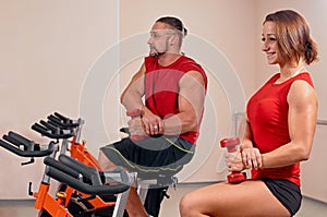 Couple bycicle cycling in gym