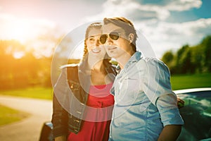 Couple with cabriolet car in spring on day trip