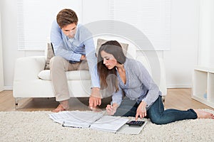 Couple calculating budget at home