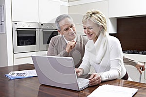 Couple Calculating Home Finances On Laptop photo