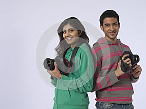 Couple With Cameras In Studio