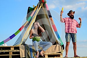 Couple camping on nature. Romantic lovers in tent at countryside. Breakfast with lovers on nature.