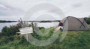 Couple camping with a tent at the seaside in Bergen, Norway