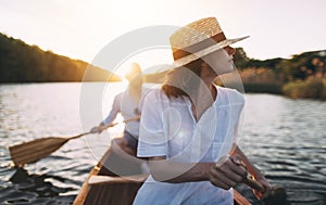 Couple canoeing on the lake at sunset