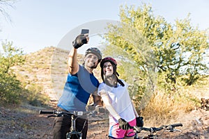 Couple Capturing Cycling Moments Via Phone