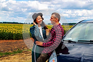 Couple on car road trip travel having coffee break outdoors smiling happy.