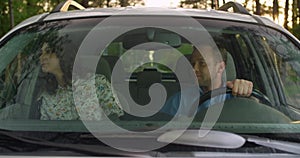 Couple in the car. wife and husband view the terrain from the car window. view through car windshield.