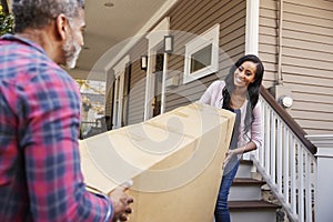 Couple Carrying Big Box Purchase Into House