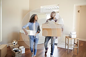 Couple Carrying Boxes Into New Home On Moving Day