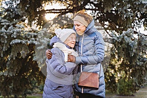 Couple of Caucasian mature woman and senior female are happy to spend time on Christmas and New Year holidays together, smiling