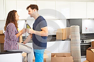 Couple Celebrating Moving Into New Home With Champagne