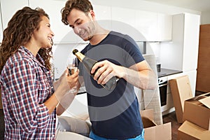 Couple Celebrating Moving Into New Home With Champagne