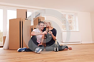 Couple Celebrating Moving Into New Home With Champagne