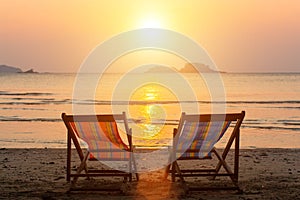 A couple of chairs on sunset beach. Relax.