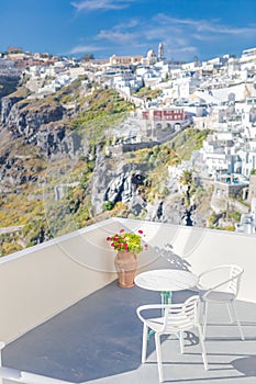 Couple chairs table on terrace. White architecture on Santorini island, Greece.