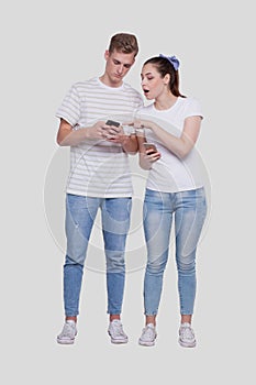 Couple Chatting on Phone. Couple Using Phones Standing Isolated. Couple Shopping Online. Girl Watching in Man Phone