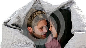 Couple chatting under the covers