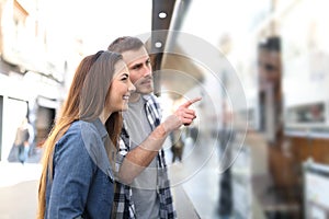 Couple checking storefront in the street