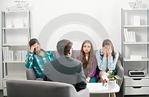 Couple with child teenager discussing problems in family with family psychologist. Parental concept.