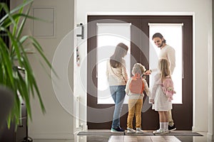 Couple with children in hallway gather for a walk