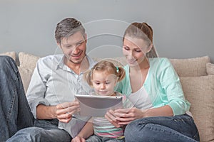 Couple with children reader watching