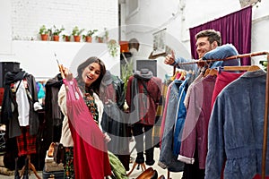 Couple choosing clothes at vintage clothing store