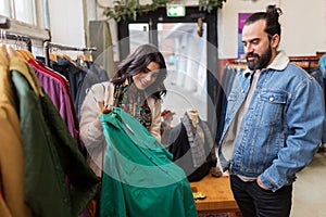 Couple choosing clothes at vintage clothing store