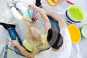 Couple choosing colors for painting new house