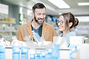 Couple choosing cosmetics in the pharmacy