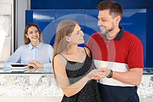 Couple choosing engagement ring in jewelry