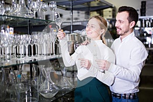 Couple choosing glasses in store