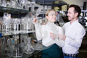 Couple choosing glasses in store