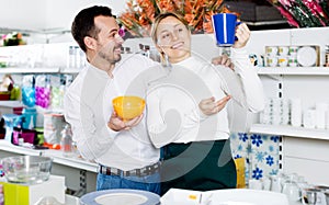 Couple choosing new crockery in dinnerware store