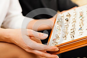 Couple choosing a ring at the jeweller photo