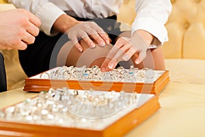 Couple choosing a ring at the jeweller photo