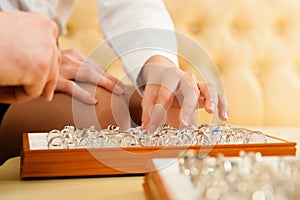 Couple choosing a ring at the jeweller photo