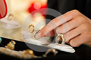 Couple choosing a ring at the jeweller photo